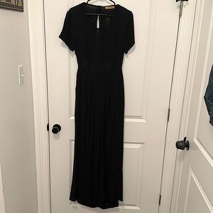Black wide leg jumpsuit, button back with an opening, has pockets